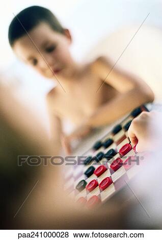 Stock Photo - Children playing checkers, blurred. Fotosearch