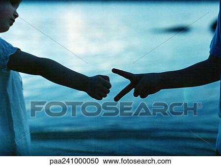Children playing 'rock paper scissors', close-up, sea in background View Large Photo Image Stock Image - Children playing 'rock paper scissors', close-up, sea in background. Fotosearch