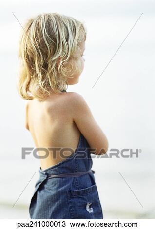 Stock Image - Girl with blonde hair, rear view. Fotosearch