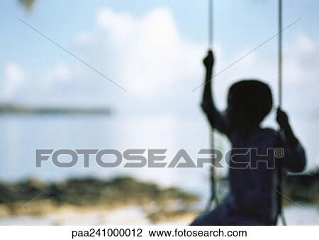 Silhouette of child sitting on swing, blurred View Large Photo Image Stock Image - Silhouette of child sitting on swing, blurred. Fotosearch