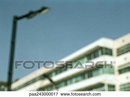 Stock Photo - Apartment building and street lamp, low angle view, blurred. Fotosearch