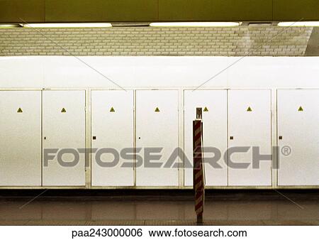 Row of doors enclosing electrical equipment in subway station View Large Photo Image Stock Photograph - Row of doors enclosing electrical equipment in subway station. Fotosearch