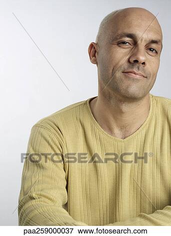 Stock Photo - Man with head slightly turned, looking at camera. Fotosearch