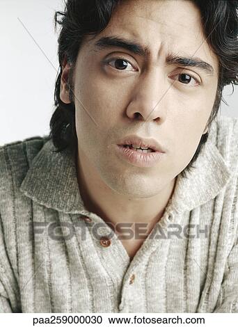 Young man looking at camera, close-up View Large Photo Image Stock Image - Young man looking at camera, close-up. Fotosearch