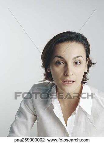 Young woman looking at camera with mouth slightly open View Large Photo Image Stock Image - Young woman looking at camera with mouth slightly open. Fotosearch
