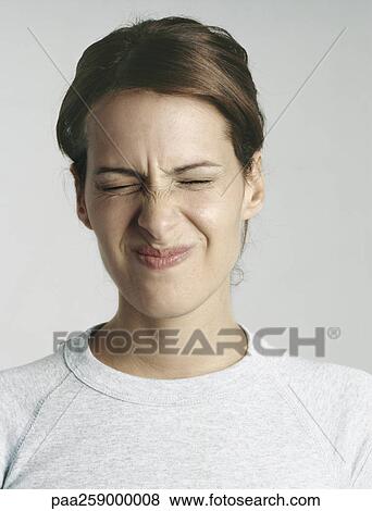 Young woman squinting eyes shut, close-up View Large Photo Image Stock Photo - Young woman squinting eyes shut, close-up. Fotosearch