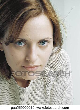 Young woman wearing sweater looking at camera, close-up View Large Photo Image Stock Photo - Young woman wearing sweater looking at camera, close-up. Fotosearch