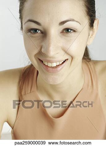 Young woman with hair back smiling, close-up View Large Photo Image Stock Photo - Young woman with hair back smiling, close-up. Fotosearch