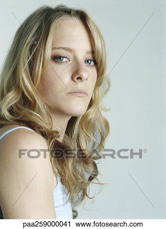 Young woman with head turned toward and looking at camera, portrait View Large Photo Image Stock Image - Young woman with head turned toward and looking at camera, portrait. Fotosearch