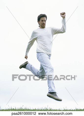 Man jumping, in mid-air, full length View Large Photo Image Stock Image - Man jumping, in mid-air, full length. Fotosearch