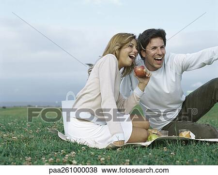 Young man and young woman having picnic View Large Photo Image Stock Photo - Young man and young woman having picnic. Fotosearch