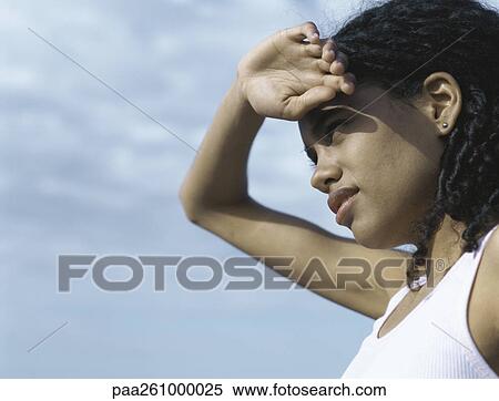 Young woman shading eyes with hand View Large Photo Image Stock Photography - Young woman shading eyes with hand. Fotosearch
