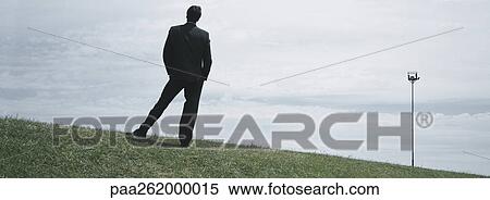 Man in suit standing on grass, full length rear view View Large Photo Image Stock Photography - Man in suit standing on grass, full length rear view. Fotosearch