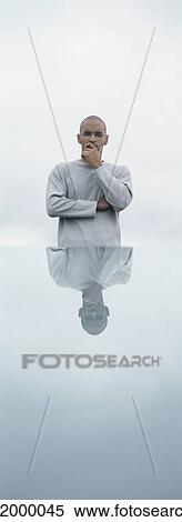 Man standing in front of table with his reflection, outdoors View Large Photo Image Stock Photography - Man standing in front of table with his reflection, outdoors. Fotosearch