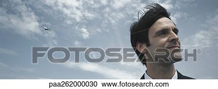 Man's head with sky in background, low angle view View Large Photo Image Stock Image - Man's head with sky in background, low angle view. Fotosearch