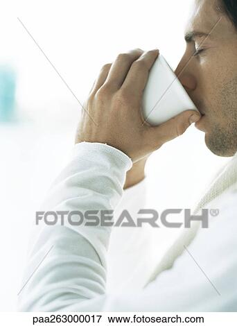 Man drinking from cup, eyes closed View Large Photo Image Stock Photo - Man drinking from cup, eyes closed. Fotosearch