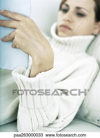 Woman lying back on pillow holding up book View Large Photo Image Stock Image - Woman lying back on pillow holding up book. Fotosearch