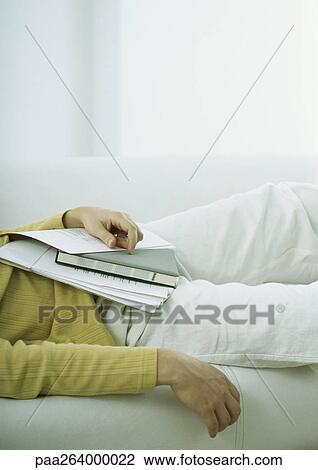 Man lying on sofa with papers and agenda on stomach, mid-section View Large Photo Image Stock Image - Man lying on sofa with papers and agenda on stomach, mid-section. Fotosearch