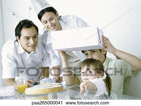 Boy and girl with parents having birthday party View Large Photo Image Stock Image - Boy and girl with parents having birthday party. Fotosearch