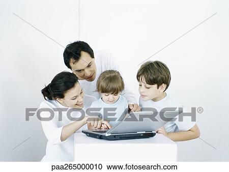 Boy and little girl with parents using laptop together View Large Photo Image Stock Image - Boy and little girl with parents using laptop together. Fotosearch