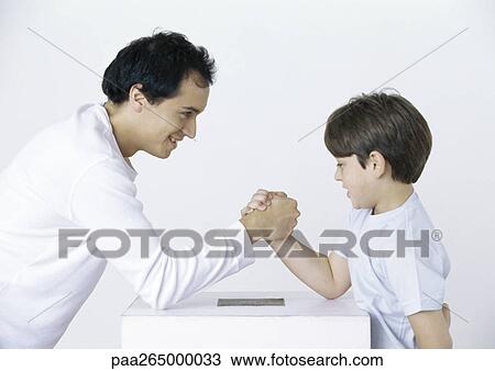 Father and son armwrestling View Large Photo Image Stock Image - Father and son armwrestling. Fotosearch