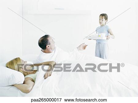 Girl bringing parents breakfast in bed View Large Photo Image Stock Photo - Girl bringing parents breakfast in bed. Fotosearch