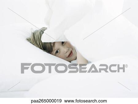 Little boy in bed, looking through pillows View Large Photo Image Stock Photo - Little boy in bed, looking through pillows. Fotosearch