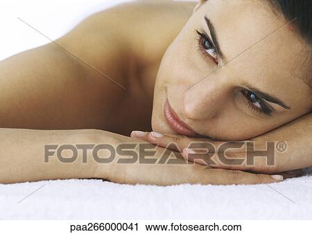 Woman laying head on hands, looking away, close-up View Large Photo Image Stock Image - Woman laying head on hands, looking away, close-up. Fotosearch