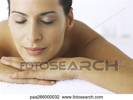 Woman lying with chin resting on hands, eyes closed, close-up View Large Photo Image Stock Image - Woman lying with chin resting on hands, eyes closed, close-up. Fotosearch
