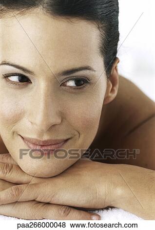 Woman smiling, head on hands, close-up View Large Photo Image Stock Photo - Woman smiling, head on hands, close-up. Fotosearch