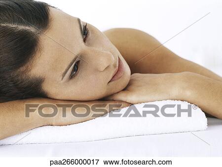Woman with bare shoulder and head on clasped hands looking away, close-up View Large Photo Image Stock Photo - Woman with bare shoulder and head on clasped hands looking away, close-up. Fotosearch