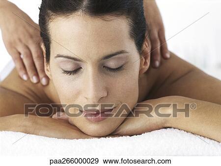 Woman with closed eyes, chin resting on hands, receiving shoulder massage View Large Photo Image Stock Photo - Woman with closed eyes, chin resting on hands, receiving shoulder massage. Fotosearch