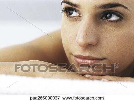 Woman with head on hands, looking away, close-up View Large Photo Image Stock Photo - Woman with head on hands, looking away, close-up. Fotosearch