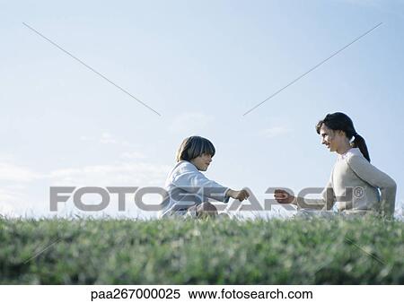 Boy and girl sitting on grass playing rock paper scissors View Large Photo Image Stock Photography - Boy and girl sitting on grass playing rock paper scissors. Fotosearch