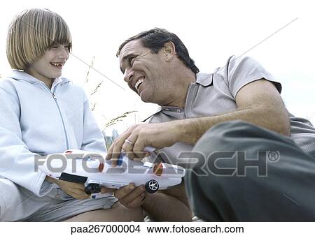 Father and son holding toy plane View Large Photo Image Picture - Father and son holding toy plane. Fotosearch