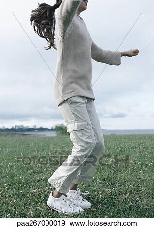 Girl jumping rope on grass View Large Photo Image Stock Photo - Girl jumping rope on grass. Fotosearch