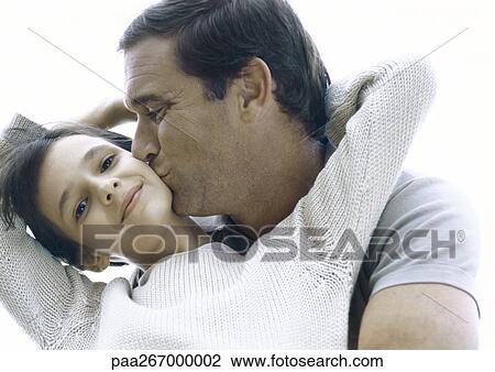 Girl reaching arms back around father's neck, father kissing girl's cheek View Large Photo Image Stock Image - Girl reaching arms back around father's neck, father kissing girl's cheek. Fotosearch