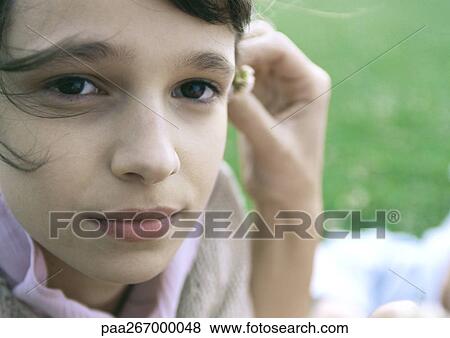 Girl's face with mother's hand putting flower behind girl's ear View Large Photo Image Stock Photo - Girl's face with mother's hand putting flower behind girl's ear. Fotosearch