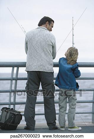Man and son fishing on pier, rear view View Large Photo Image Stock Image - Man and son fishing on pier, rear view. Fotosearch