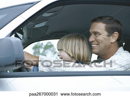 Man driving car with son on lap, side view View Large Photo Image Stock Image - Man driving car with son on lap, side view. Fotosearch