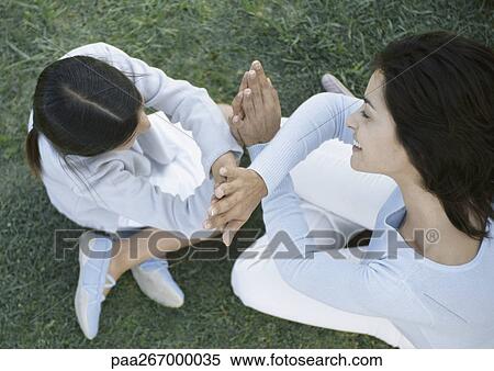 Mother and daugther playing clapping game View Large Photo Image Stock Photography - Mother and daugther playing clapping game. Fotosearch