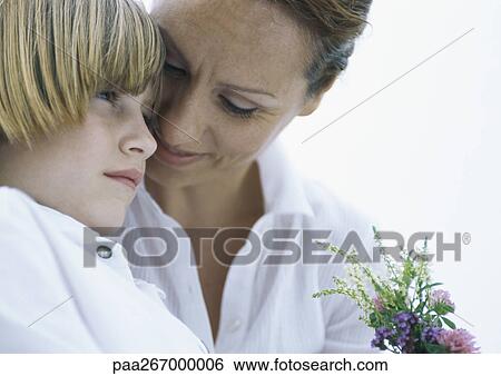 Mother and son with bouquet of wildflowers View Large Photo Image Stock Photograph - Mother and son with bouquet of wildflowers. Fotosearch
