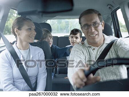 Parents with boy and girl in car wearing seatbelts, interior view View Large Photo Image Stock Image - Parents with boy and girl in car wearing seatbelts, interior view. Fotosearch