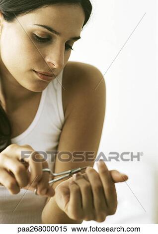 Woman cutting nails with nail scissors View Large Photo Image Stock Photography - Woman cutting nails with nail scissors. Fotosearch