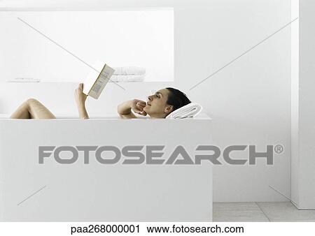 Woman reading in bathtub View Large Photo Image Stock Image - Woman reading in bathtub . Fotosearch