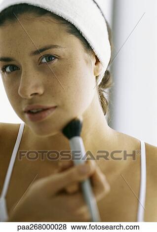 Young woman applying make-up with blush brush View Large Photo Image Stock Photo - Young woman applying make-up with blush brush. Fotosearch