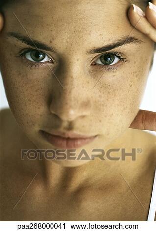 Young woman looking at camera, close-up View Large Photo Image Stock Image - Young woman looking at camera, close-up. Fotosearch
