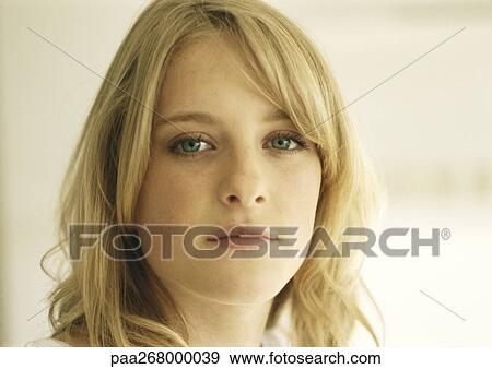 Stock Photo - Young woman looking at camera, portrait. Fotosearch