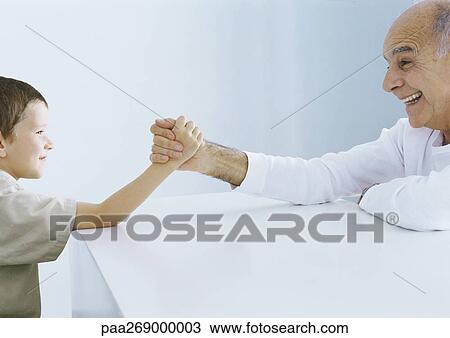 Boy arm wrestling with grandfather View Large Photo Image Stock Image - Boy arm wrestling with grandfather. Fotosearch