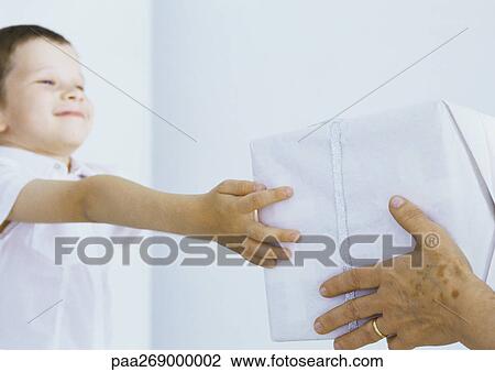 Boy reaching out receiving package View Large Photo Image Stock Image - Boy reaching out receiving package. Fotosearch